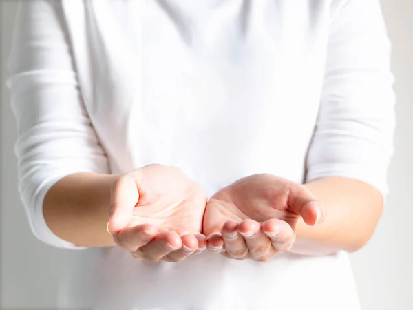 Close-up of a woman open palms of two hands for prop up for something; or beg for something. selective focus inside palms.