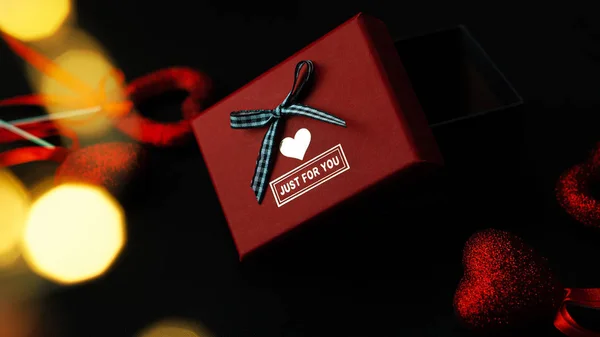 Een Cadeau Voor Valentijnsdag Tussen Glanzende Rode Harten Een Zwarte — Stockfoto