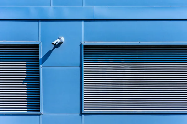 facade of industrial building with security camera