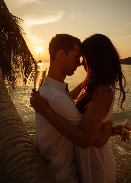 Romantic Portrait Of Happy Couple In Love On The Beach At The Sunset On Tropical Island Romantic Portrait Of Happy Couple In Love On The Beach At The Sunset On Tropical Island