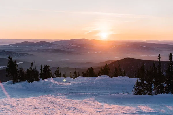 Puesta de sol en una pista de esquí de invierno — Foto de Stock
