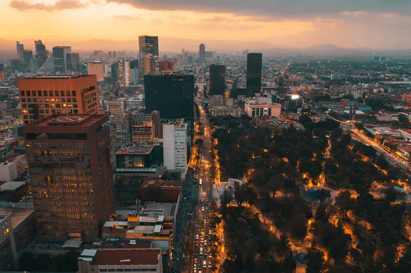 View from the drone of the streets and houses of the metropolis in Mexico City at sunset