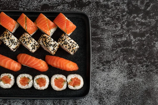 Sushi Uppsättning Nigiri Och Maki Rullar Serveras Stenplatta Mörk Sten — Stockfoto