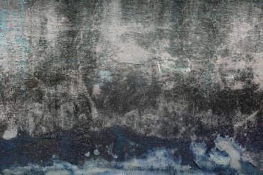 Tahıllı ve çizikli eski renkli duvarın soyut koyu dokusu. Güzel, sanatsal, yaratıcı bir geçmişi var. Mavi, beyaz ve siyah pürüzlü taş dokusu. Boşluğu kopyala