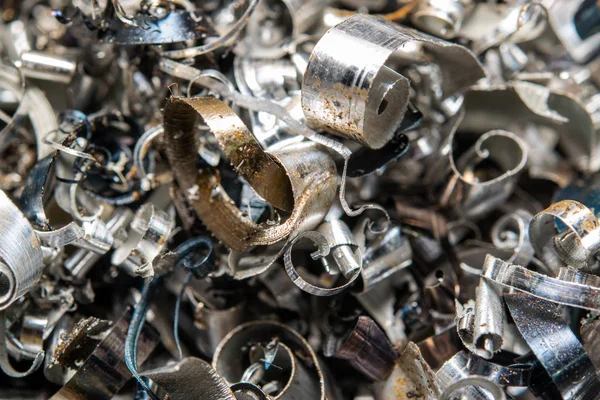 Industrial waste in the form of sharp metal chips. Industrial metal debris.