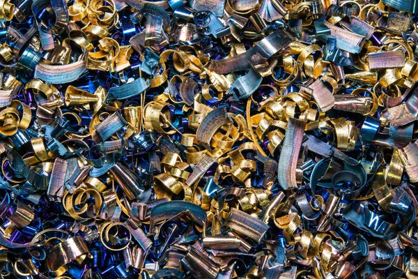 Metal shavings close-up multicolored. the waste after processing of metal drill to the lathe.