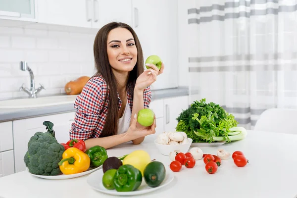 Girl Sitting at a Kitchen Desk With Various Greengrocery — Stock Photo, Image