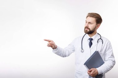 Intelligent Physician in White Smock Pointing at Something