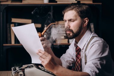 Stylish Male Writer With Tie and Braces Smoking Pipe