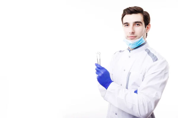 Joven dentista guapo posando con odontología Armamentarium — Foto de Stock