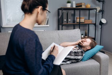 Terapistle seans sırasında ağlayan sakallı olgun bir hasta.