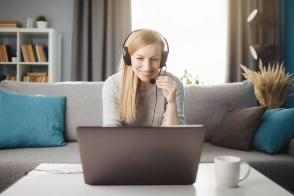 Kulaklıklı mutlu bayan dizüstü bilgisayarında video konferansı yapıyor. — Stok fotoğraf