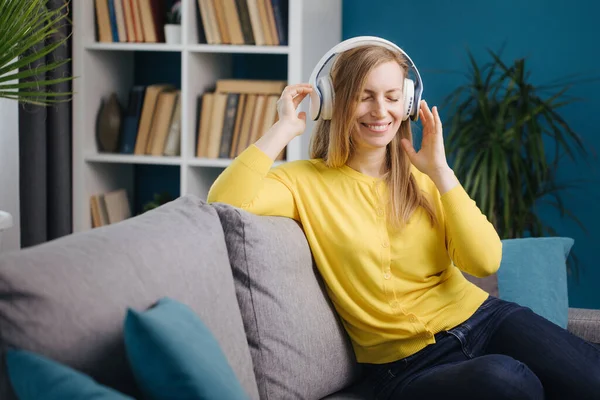 Mujer feliz disfrutando de canciones favoritas en auriculares — Foto de Stock