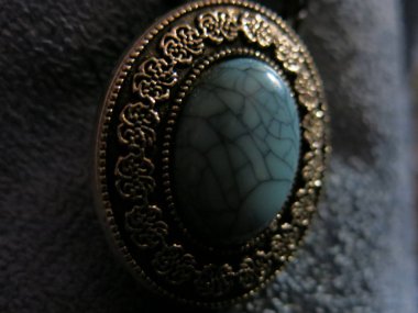 turquoise vintage brooch in a frame