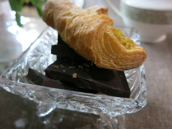 tea with croissant, creamer and candy maker