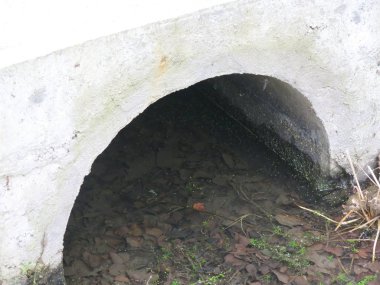 Su akışı için beton köprünün altındaki boru.