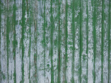 Dikey tahtaları ve yeşile boyanmış eski bir çitin dokusu. Ama solmuş ve boyası zamanla soyulmuş.