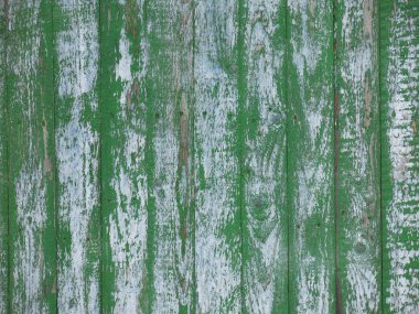 Dikey tahtaları ve yeşile boyanmış eski bir çitin dokusu. Ama solmuş ve boyası zamanla soyulmuş.