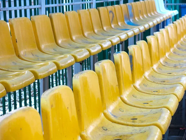 empty stands of a football stadium with yellow seats