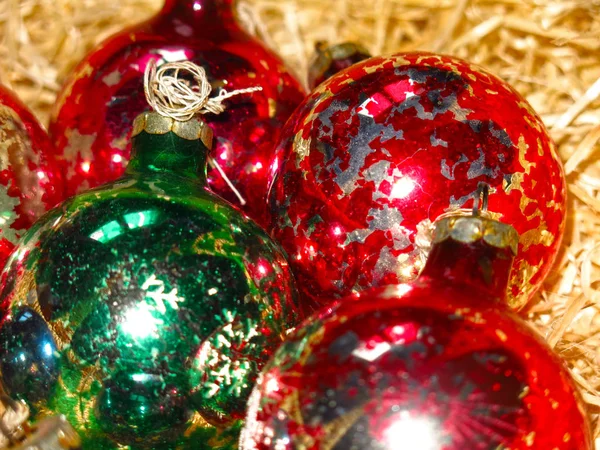Multicolored Vintage Glass Christmas Balls Peeling Paint Straw Background Stock Picture