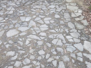 Kırık gri asfalt parçaları yolu