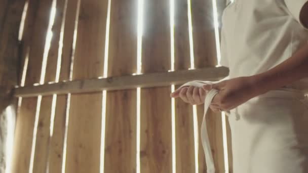 Young baker in wooden bakery prepares for work. — ストック動画