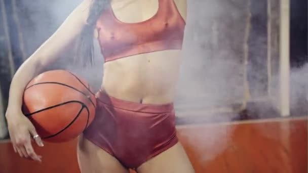 Sexy beautiful girl in underwear posing with basketball in school gym in the style of 80 years — Stock Video