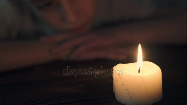 Sad little girl with a candle — Stock Video