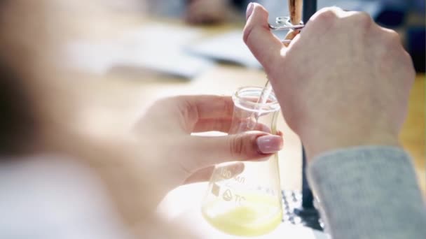 The researcher pouring the liquid — Stock Video