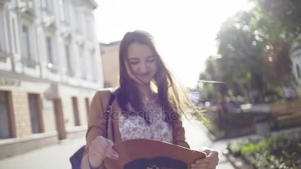 Video of young woman putting hat on her head — Stock Video