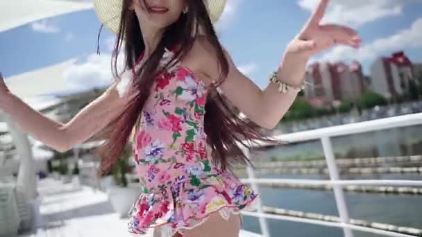 Stylish girl wearing colourful swimsuit outdoors. — Stock Video