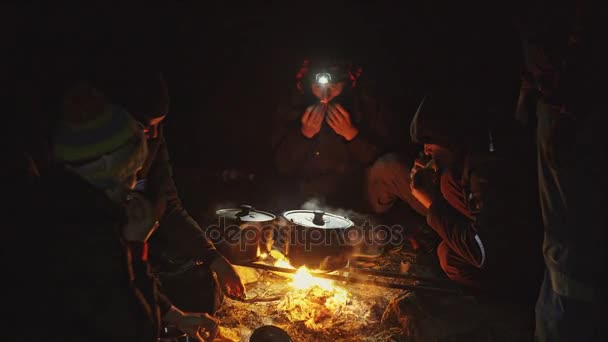 Group of friends sitting around a campfire — Stock Video