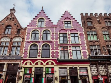Brugge, Belgium - February 25 2017 : Beautiful and colorful little buildings facade in Bruges at the Market Square