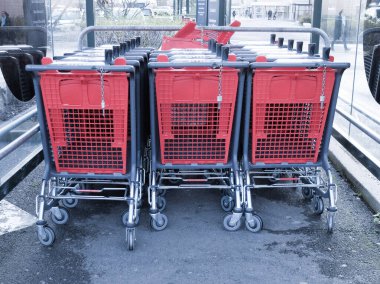 Shopping trolleys outside the supermarket Auchan clipart