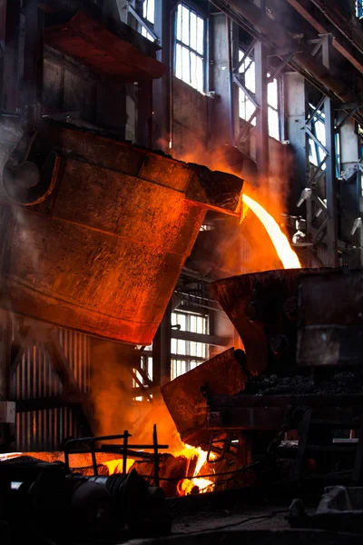 Metallurgy plant factory workshop. Filling of metal in metallurgical bucket.