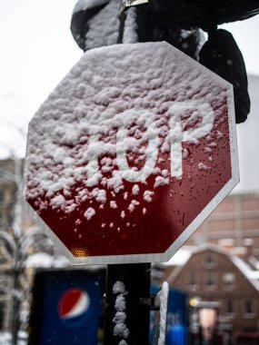 A Partially Covered Stop Sign in a Snow Storm clipart