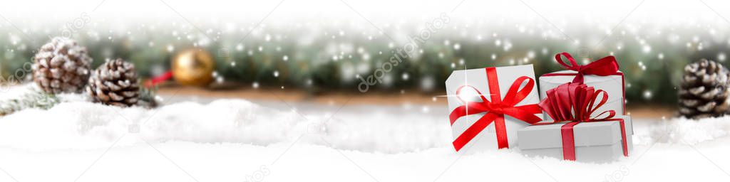 Group of Gifts with Red Ribbons on Spruce Branch Background
