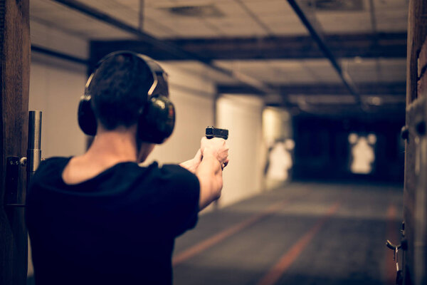 Man shooting in indoor firing range