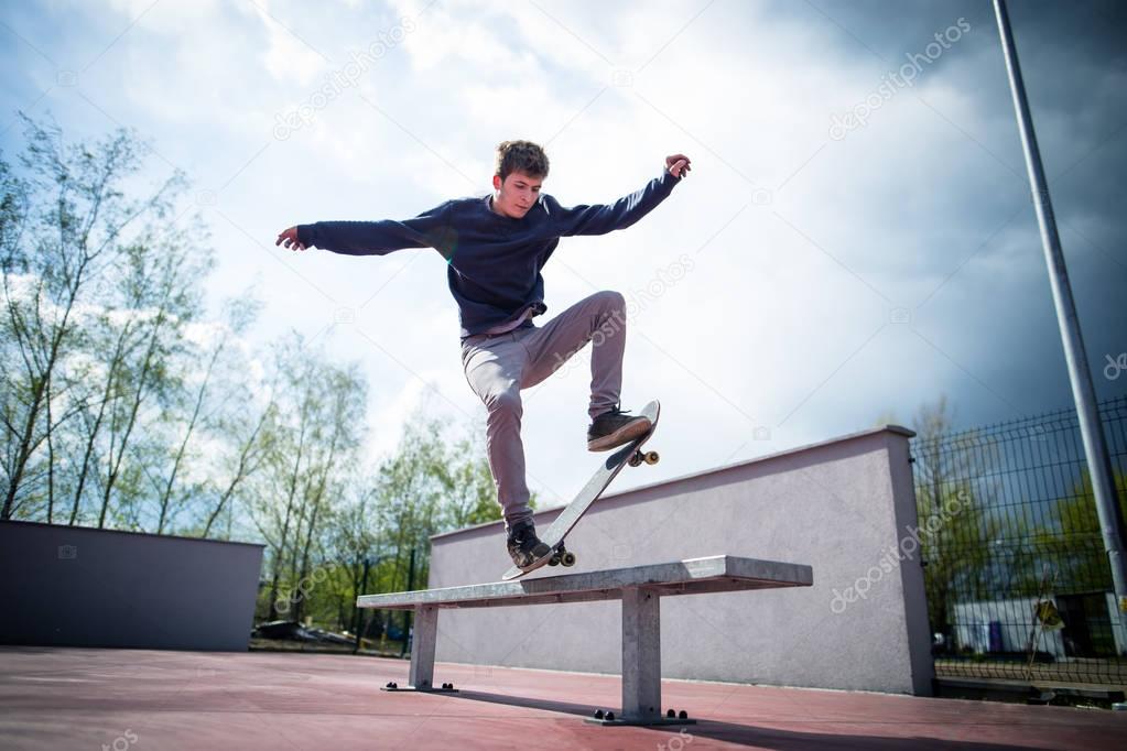 Skater doing bluntslide trick on bench