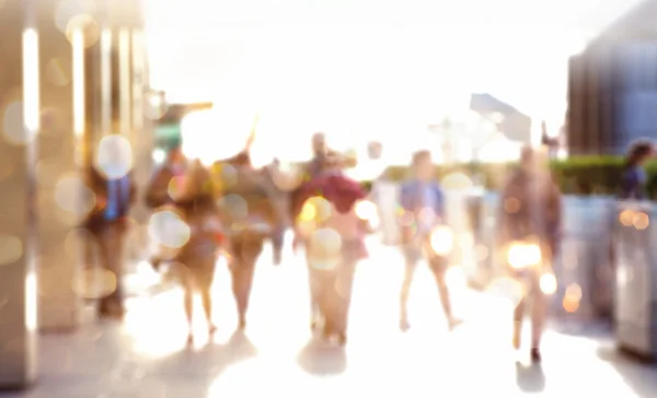 Mensen uit het bedrijfsleven lopen in de stad, licht wazig beeld met reflectie. Business en moderne leven concept — Stockfoto
