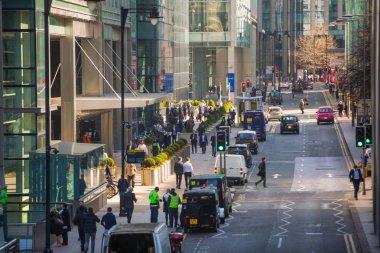 Canary Wharf street view with lols of walking business people and transport on the road. Business and modern life of London clipart