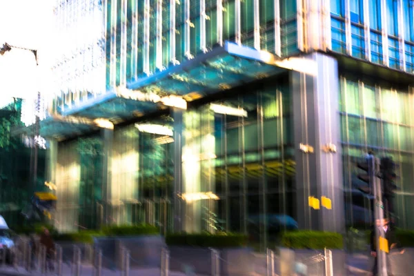 Modern architecture of Canary Wharf with people walking blur.  Multiple exposure image — Stock Photo, Image