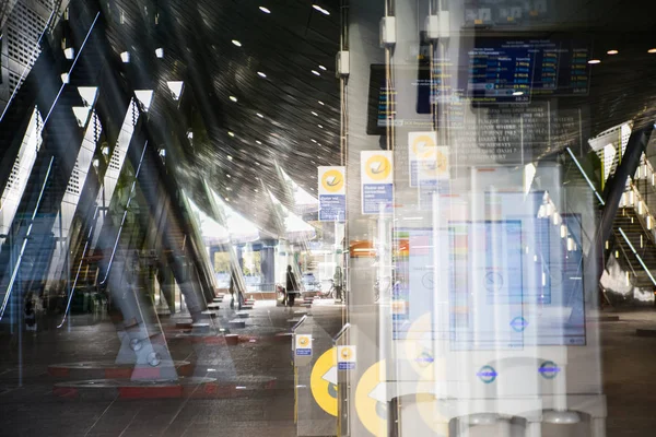 Modern architecture, Train station with escalators, supportive metal beams, tickets machine. Multiple exposure image — Stock Photo, Image