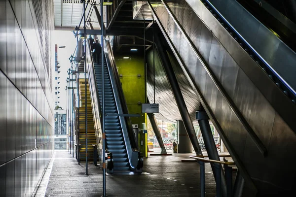 Modern architecture, Train station with escalators, supportive metal beams, tickets machine. Multiple exposure image — Stock Photo, Image