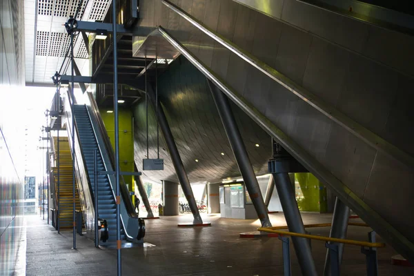 Modern architecture, Train station with escalators, supportive metal beams, tickets machine. Multiple exposure image — Stock Photo, Image