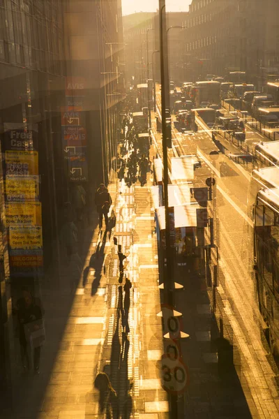 Multiple exposure image of the York road at sunset. Buses, cars and walking people against of sun. London — Stock Photo, Image