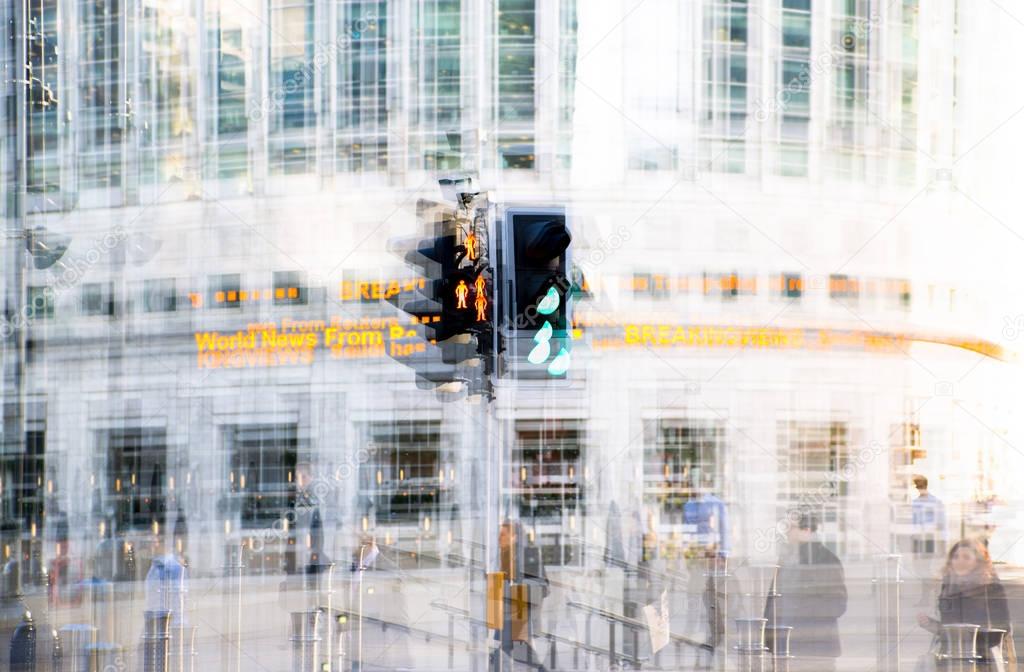 Multiple exposure effect image. Traffic light showing red against of modern office block building. Business and modern life concept.