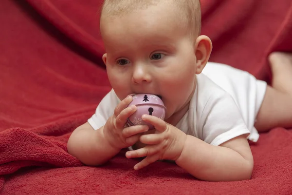 Infant baby on a red rug — Stock Photo, Image