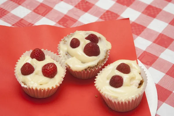 Strawberry cupcakes on the red background.