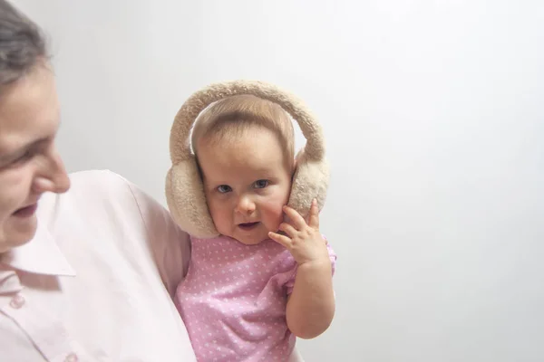 Csecsemő Kislány Téli Fülhallgatóban Anya Kezén Fehér Alapon — Stock Fotó